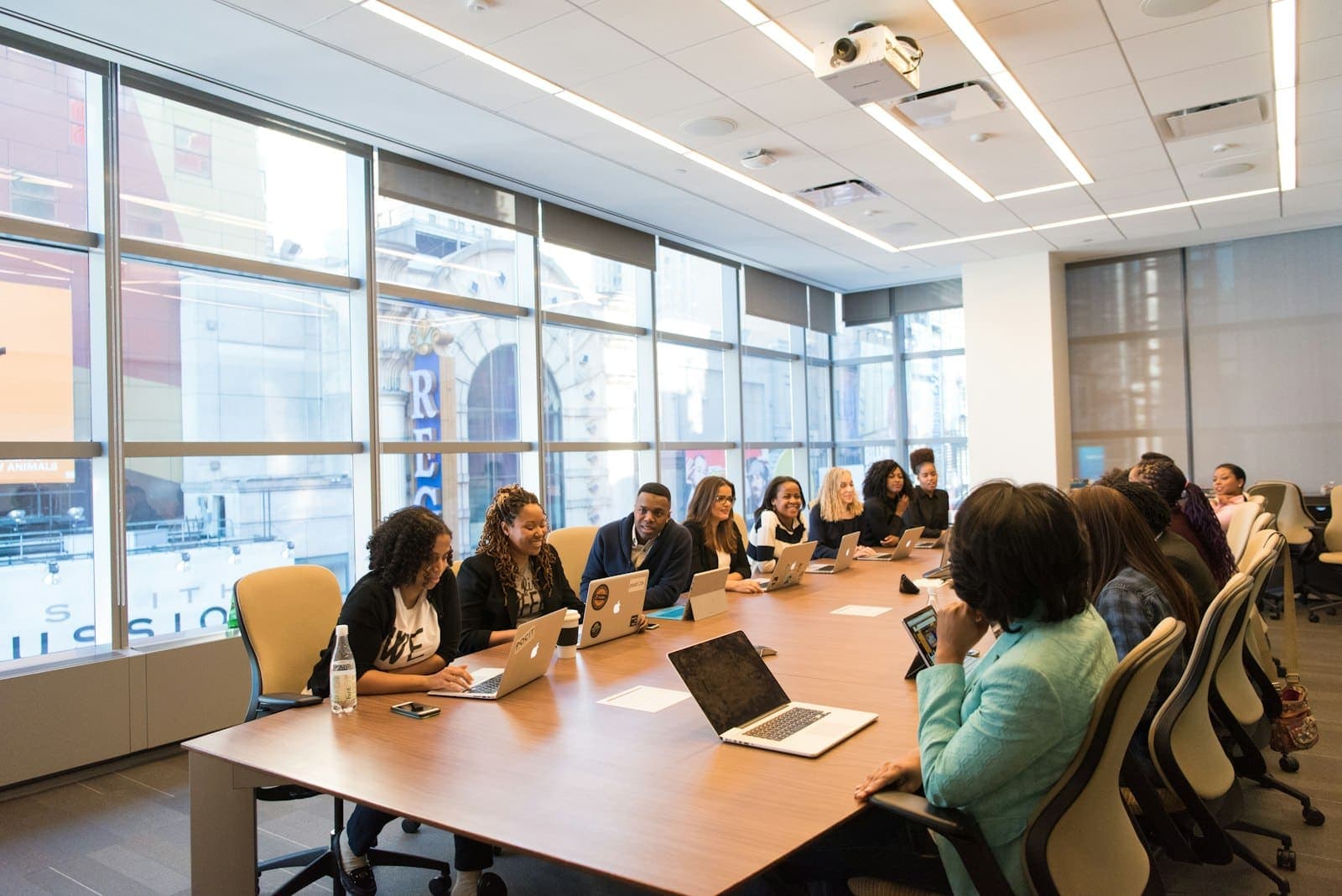 A corporate training class with laptops in a meeting room